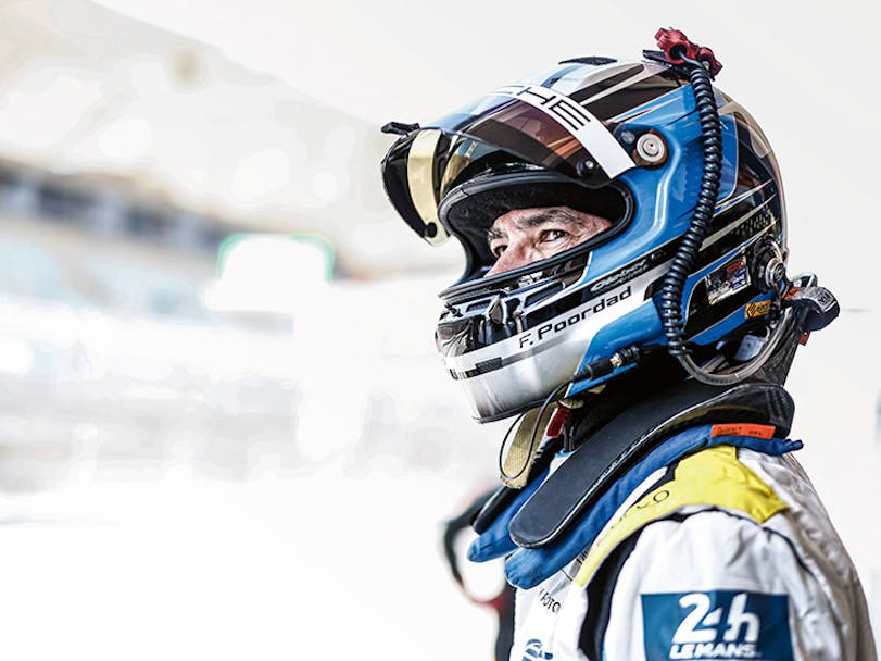 Racing driver, wearing helmet, with visor up