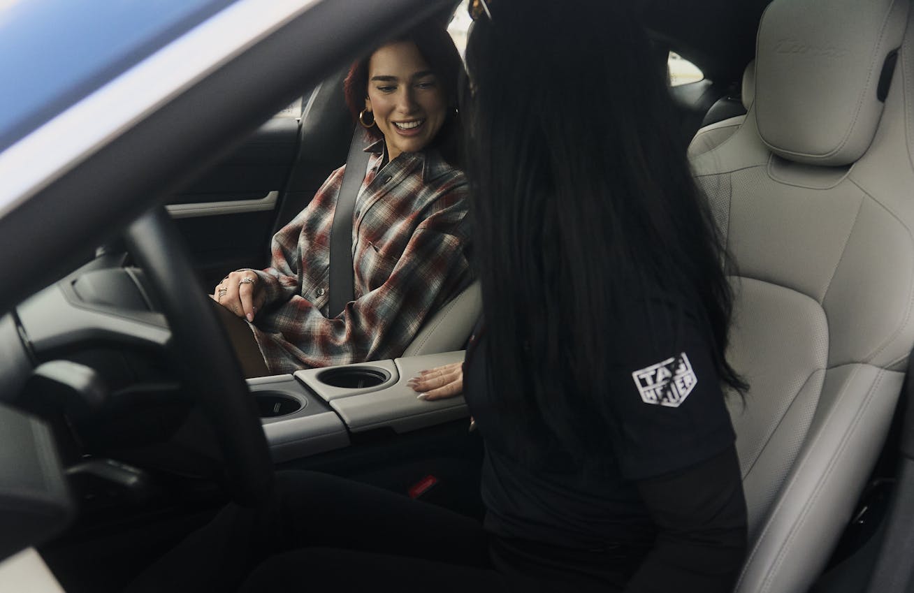 Dua Lipa sits in Porsche Taycan Turbo with Porsche instructor