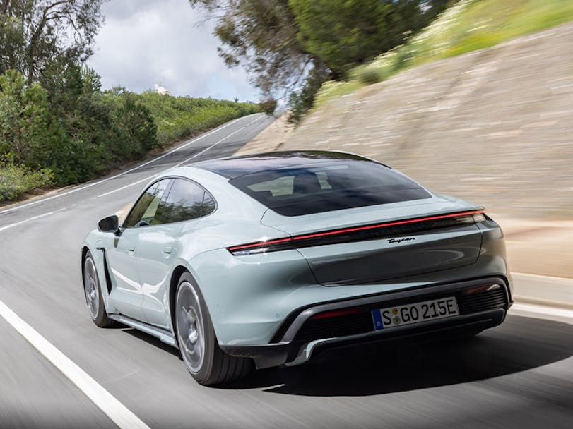 Porsche Taycan in Shade Green Metallic driving on Spanish road