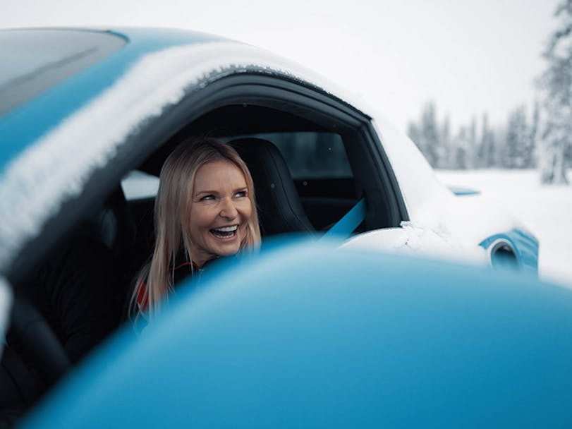 Woman looks out of window of Porsche 911 Turbo S 